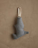 The Coral & Tusk Downhill Bear Ornament is a small, abstract-shaped fabric decoration in muted gray with a cream loop for hanging, adding winter charm to any beige textured wall.