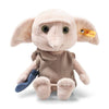 The Steiff Harry Potter “Dobby” with Sock 10" plush features large ears, green eyes, a beige tunic, holds a blue sock in its left hand, and has a yellow Steiff tag on its right ear.