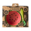 The Wally the Watermelon Bowl & Spoon Set by Oli & Carol includes a non-toxic watermelon-themed bowl and a green leaf-shaped wooden spoon. Packaged for babies 6 months+, it's a boxed baby dinnerware set.