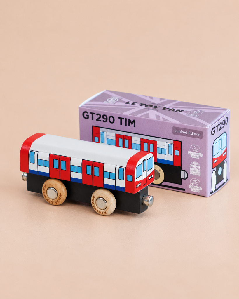 A toy train painted red, white, and blue stands in front of a purple box labeled “No. 48 GT290 Tim | Made in England.” Perfect for imaginative play, the box features an image of the toy and displays the words “Limited Edition” on the top right corner.