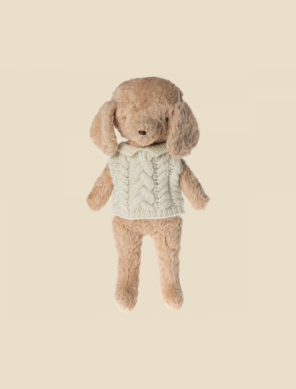 A plush toy rabbit with a Maileg Puppy Sweater - Off White featuring a tail hole, against a soft yellow background. The rabbit has floppy ears and appears soft and cuddly.