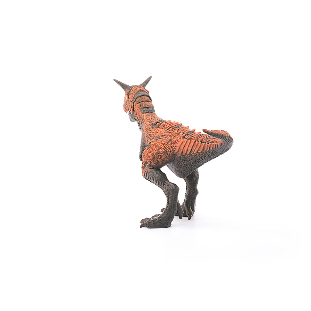 A plastic orange and brown Schleich Carnotaurus Large Realistic Dinosaur Toy with a movable jaw is depicted standing on two legs against a white background, facing away from the camera. This detailed toy is an excellent educational choice for young paleontology enthusiasts.