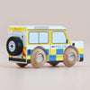 The No. 40 GT250 Bobby | Made in England is a wooden police car styled as a British patrol vehicle, painted in yellow, blue, and white with black wheels and “POLICE” written on the side—perfect for imaginative play and shown against a plain background.
