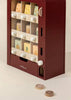 The Wooden Play Vending Machine features a maroon frame, white knobs, colorful fruit and cheese blocks, and two coin-like pieces—an ideal pretend play toy that helps children develop motor skills.