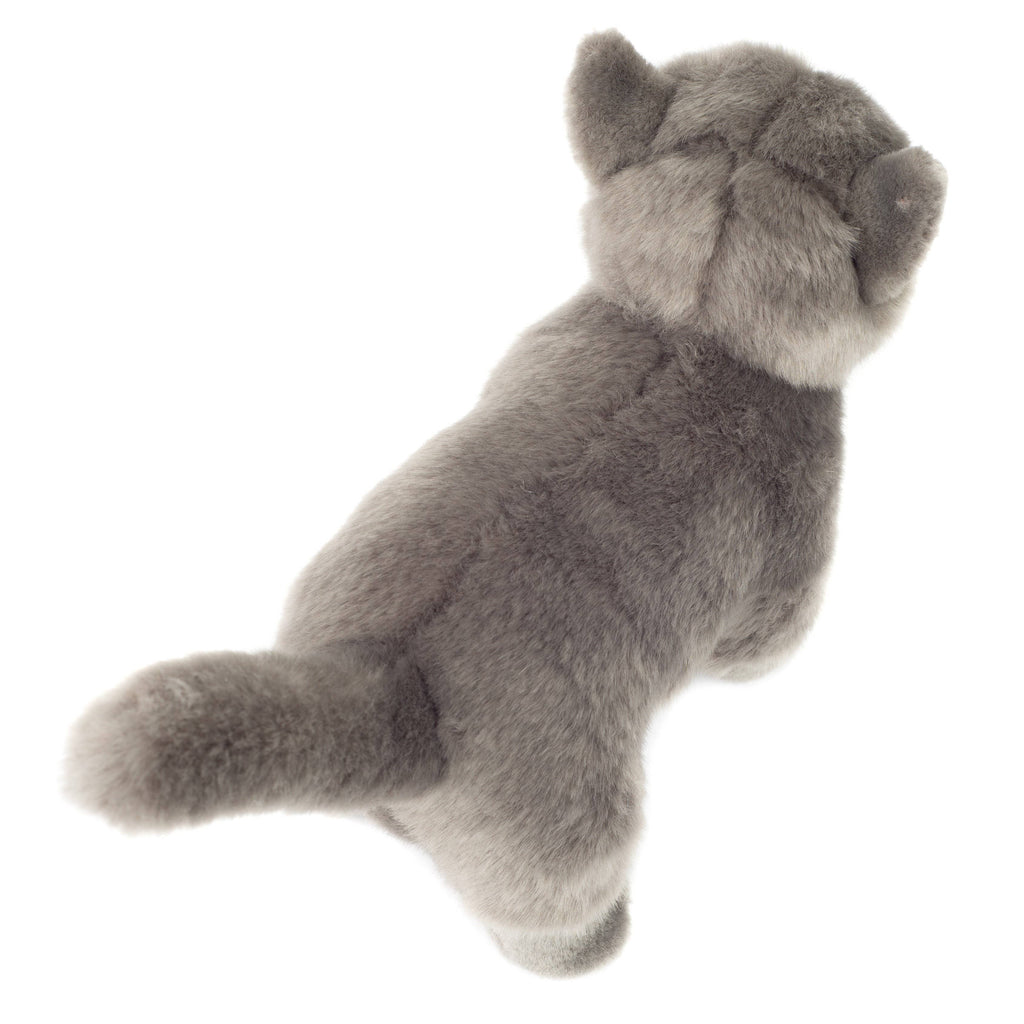 A plush toy from the Hermann Teddy Collection resembling a gray standing cat, viewed from behind, showcases its fluffy tail, pointed ears, and soft, gray fur. This lifelike plush toy features a child-friendly design perfect for young ones to cuddle and cherish.