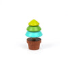 The Wooden Spinning Top - Tree features three vibrant stacked sections in yellow-green, teal, and blue-green on a brown base, crafted from sustainable wood for timeless play, shown against a plain white background.