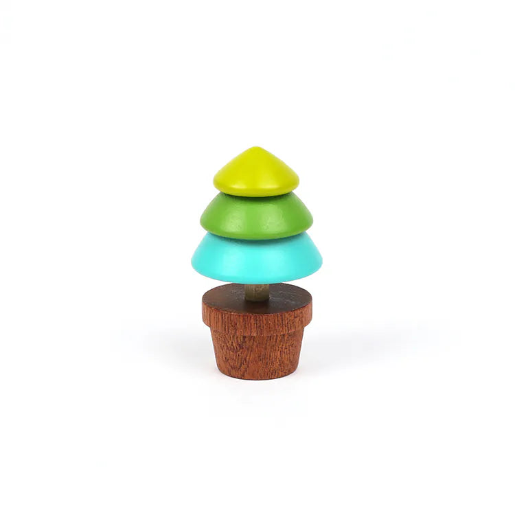 The Wooden Spinning Top - Tree features three vibrant stacked sections in yellow-green, teal, and blue-green on a brown base, crafted from sustainable wood for timeless play, shown against a plain white background.