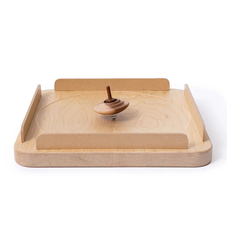 The Wooden Spinning Top Tray includes a light-colored maple wood tray with raised, detachable sides for easy access, and a wooden spinning top. Both are crafted from maple wood for a cohesive look.