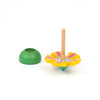 The Wooden Spinning Top - Yellow Flower, crafted from sustainable beech wood with a floral design and wooden stem, sits beside a green rounded base on a white background—ideal for timeless play.