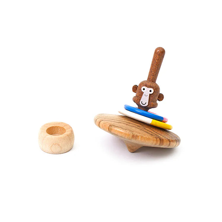 The Wooden Spinning Top - Monkey features a playful monkey face and colorful rings, crafted from sustainable wood for timeless fun, shown with a small ring on a white background.