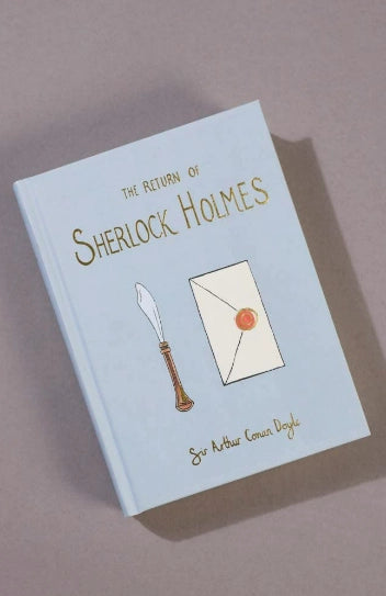 The Return of Sherlock Holmes | Collector's Edition is a light blue hardcover book featuring quill and sealed envelope illustrations on the cover.