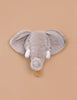 The Coat Hanger - Elephant features a plush gray elephant head with big floppy ears and white tusks on a tan background, serving as both a cute soft toy wall decor and a functional coat hanger.