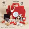 The Pretend Play Vintage Doctor Set features a red toy medical bag with a cross, plus wooden instruments like a stethoscope, syringe, scissors, medicine bottle, blood pressure cuff & ointment. Includes 10 pieces and "Hand Made with Love" text—perfect for kids' role play!.
