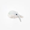 A handcrafted BigStuffed Mini Grandma Whale comforter with a long, pointed snout and fluffy underbelly. The mini whale has a textured body with a visible eye on the side. Made in Lithuania, it sits against a plain white background, highlighting the detailed craftsmanship of this plush toy.