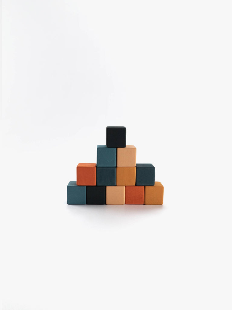 A petite pyramid constructed from Sabo Concept Mini Wooden Blocks - Tropics, featuring vibrant shades of orange, black, teal, and peach, stacked neatly against a white background. These educational toys are ideal for fostering fine motor skills in young children.