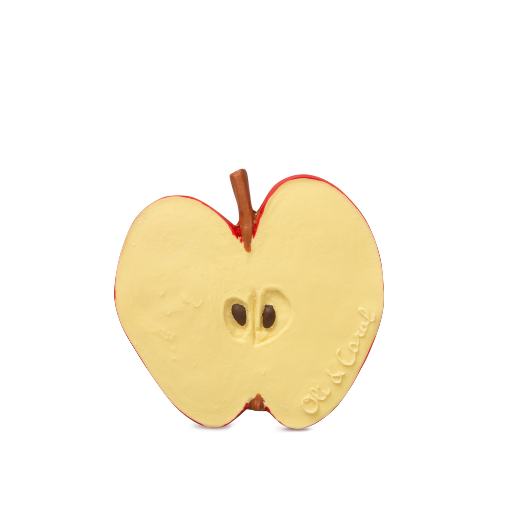 Pepita the Apple Teething Toy is shaped like a sliced red apple with a brown stem and two seeds, made from natural rubber. "Oli & Carol" is embossed on the lower right side. Ideal as a baby teether. Plain white background.