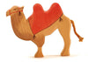 The Ostheimer Camel With Saddle is a handcrafted wooden camel figurine featuring two humps and a vibrant red painted saddle blanket. It's ideal for imaginative play, showcasing a rope-like tail and simple carved details, presented against a plain white background.