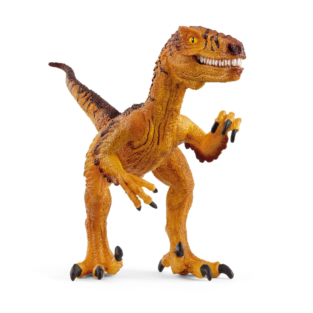 The Schleich Velociraptor is a yellow and brown dinosaur figurine with sharp teeth and claws, standing on two legs with its mouth open to reveal a movable jaw and its tail extended—making it a popular toy for imaginative play.