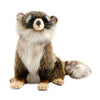The Young Raccoon Stuffed Animal sits upright with soft, realistic brown, black, and white fur, a fluffy striped tail, and an adorable expression—one of HANSA animals’ beautifully hand-sewn plush toys renowned for lifelike detail.