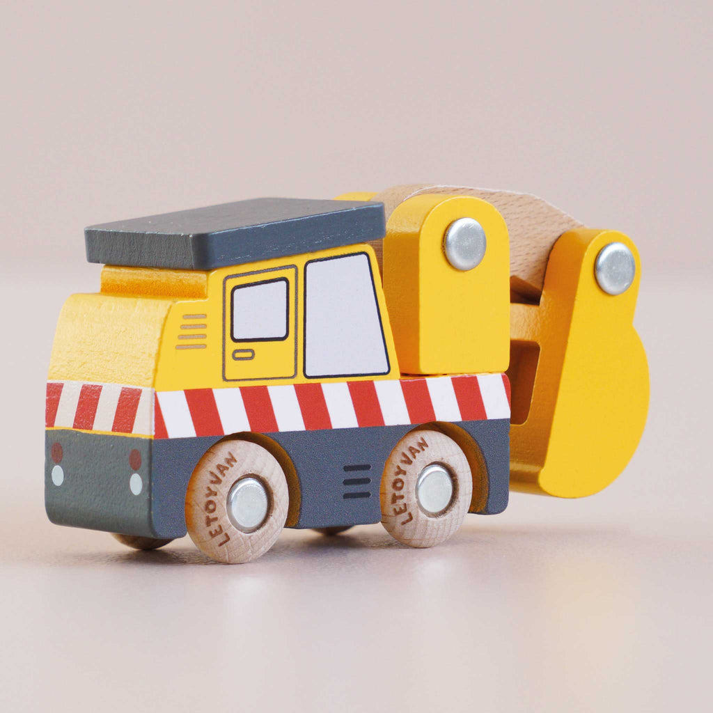 A No. 37 GT210 Eddie yellow wooden excavator construction toy, made in England, featuring red and white stripes, black wheels, and a movable arm and bucket, is shown on a light background.
