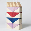 The Grimm's Small Building Block Set - Rhythm features geometric wooden blocks in natural, purple, red, and blue triangles stacked vertically—ideal as a unique addition to any tiny art collection.