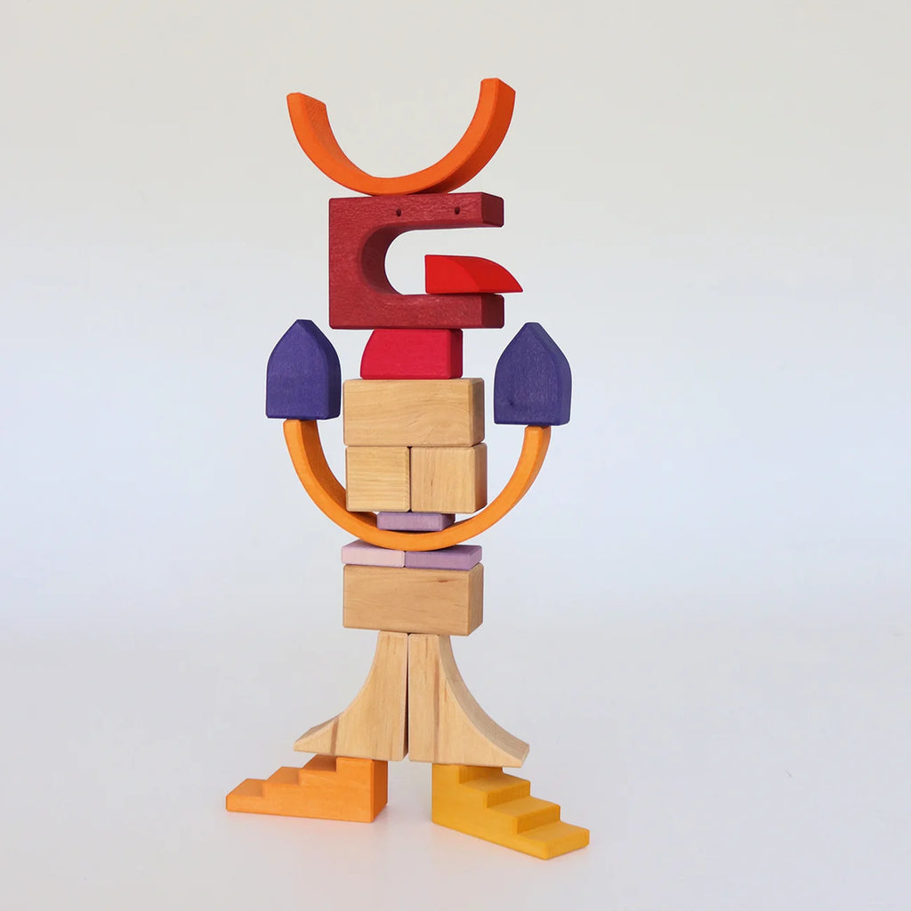 A bird-like creature constructed from Grimm’s Building World - Desert Sand, featuring orange, red, purple, and natural wood blocks in an imaginative free-build.