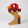 Grimm's Building Set - Red features colorful blocks in red, yellow, orange, and purple stacked to create a stylized bird with a distinct body, beak, and wings against a plain white background.