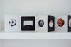Baby's Tummy Time Sports features illustrated flashcards displayed on a white shelf, providing visual stimulation with images of a soccer ball, soccer goal, bowling ball, bowling pins, basketball, and basketball hoop—perfect for tummy time or pairing with a high-contrast board book.
