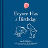 The blue hardcover "Winnie-the-Pooh: Eeyore Has A Birthday" features Eeyore and Pooh in line art by E.H. Shepard with a pink balloon above them—a charming classic children’s story by A.A. Milne.