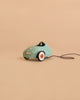 The Maileg Car, Mouse - Light Mint (ships in 1-2 weeks), a small mint-green pull-along car featuring white and orange wheels and a black pull string, sits on a plain beige background.