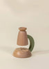 The Little Scientist Wooden Microscope features a minimalist design with a rounded base, curved green arm, and cylindrical top, set against a beige background. This modern science toy inspires curiosity in children.