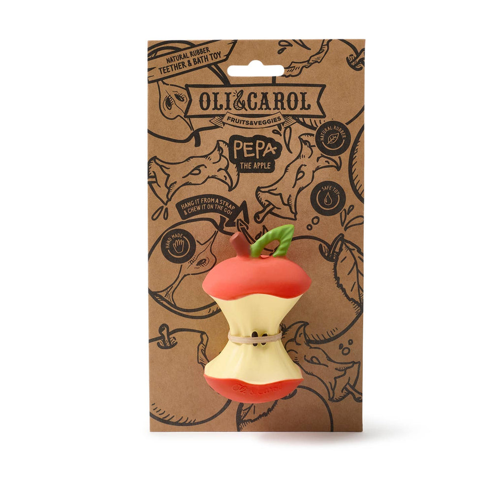 Pepa the Apple Teething Toy by Oli & Carol is a natural rubber toy shaped like a bitten apple with a green leaf, attached to eco-friendly packaging featuring apple prints. Ideal as a teether or eco-friendly bath toy for babies.