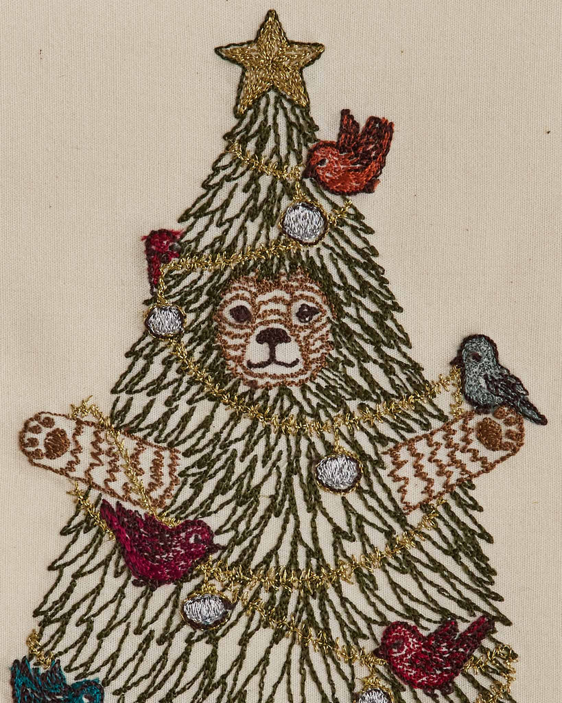 The Coral & Tusk Christmas Tree Bear Card features an embroidered tree with a bear’s face and paws peeking through branches, decorated with a gold star, metallic garland, small ornaments, and three birds.