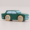 A No. 3 GT20 Tommy, a small green retro wooden car with simple painted details and natural wood wheels, made in England, is shown on a plain light background.
