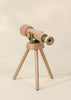 The Wooden Tripod Telescope – 15x Zoom features green accents, a simple three-legged wooden stand, and is displayed against a plain beige background.