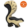 A wooden Holztiger Skunk with a natural beige and black color pattern is shown. The handcrafted wood skunk has a distinct, curved tail held high. A small orange circle in the image contains the text "spiel gut," indicating it has received a quality recommendation. HOLZTIGER figures are made in Europe.