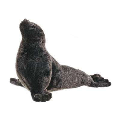A Sea Lion Cub Stuffed Animal, designed with dark gray fur, sits in a profile pose with its head tilted upwards. Its flippers are spread out, resting on a white background. This hand-se