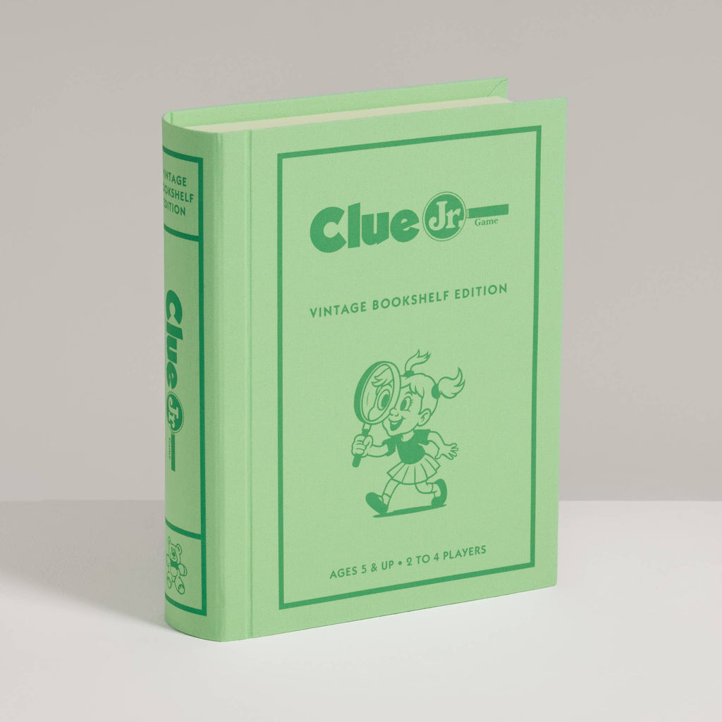 A light green Clue Jr. Vintage Bookshelf Edition board game box featuring an illustration of a child with a magnifying glass, labeled for ages 5 and up with 2 to 4 players.