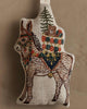 Coral & Tusk Christmas Donkey Ornament featuring an embroidered natural linen donkey carrying a stack of wrapped gifts and a small pine tree on its back.