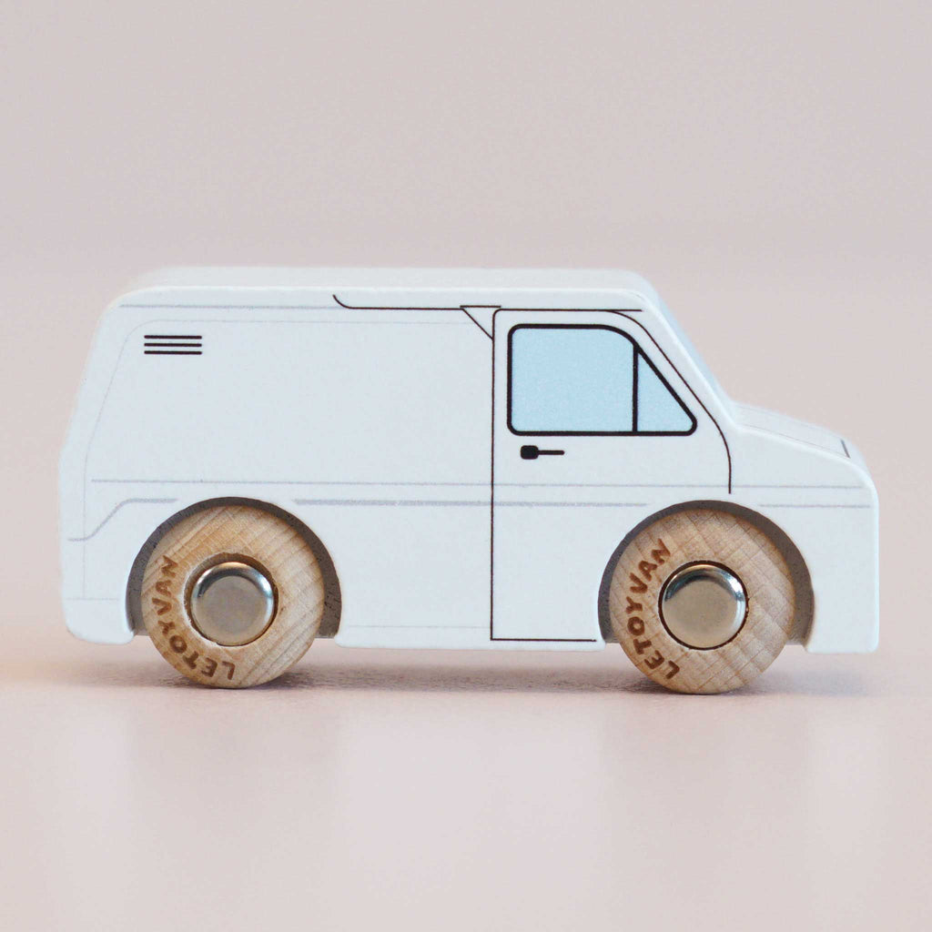 Presenting the No. 32 GT175 Frank | Made in England, a classic wooden toy van finished in white with black outlines and natural wood wheels—ideal for imaginative play and beautifully photographed against a plain light background.