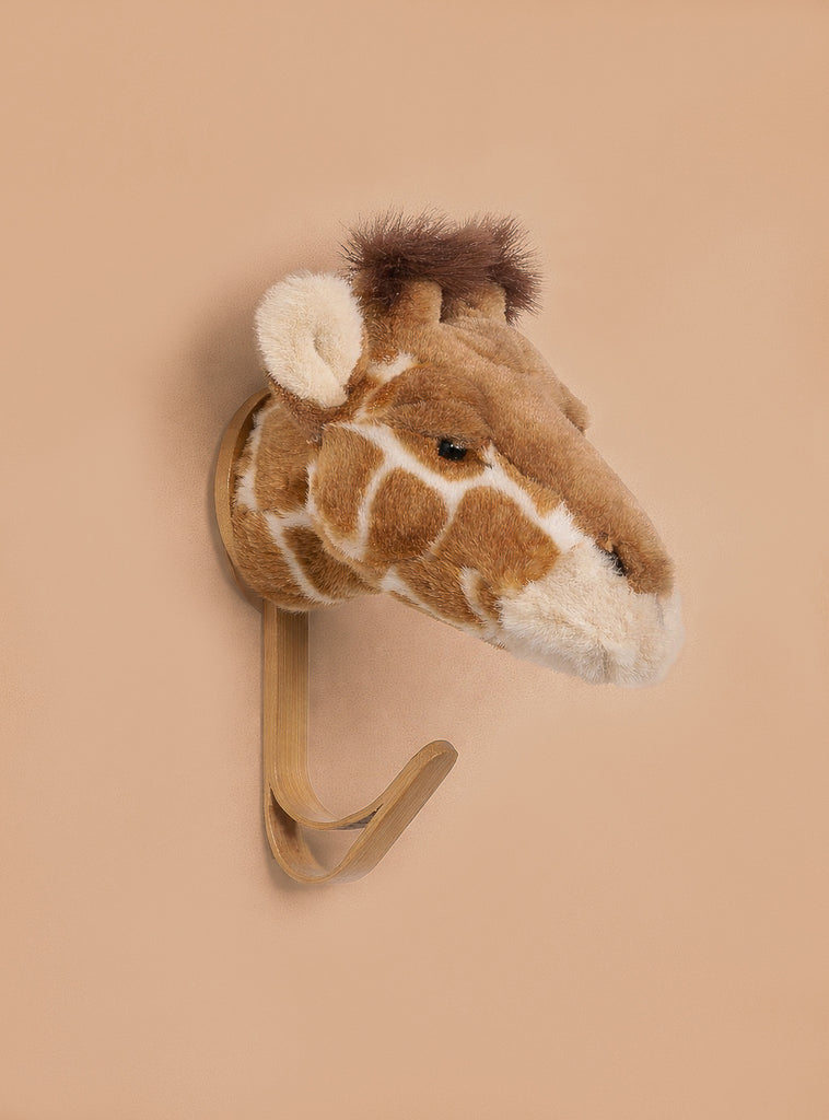 The Coat Hanger - Giraffe features a giraffe head design in soft plush with brown and cream patterns, mounted on a tan background, making it a charming animal-themed wall hook.