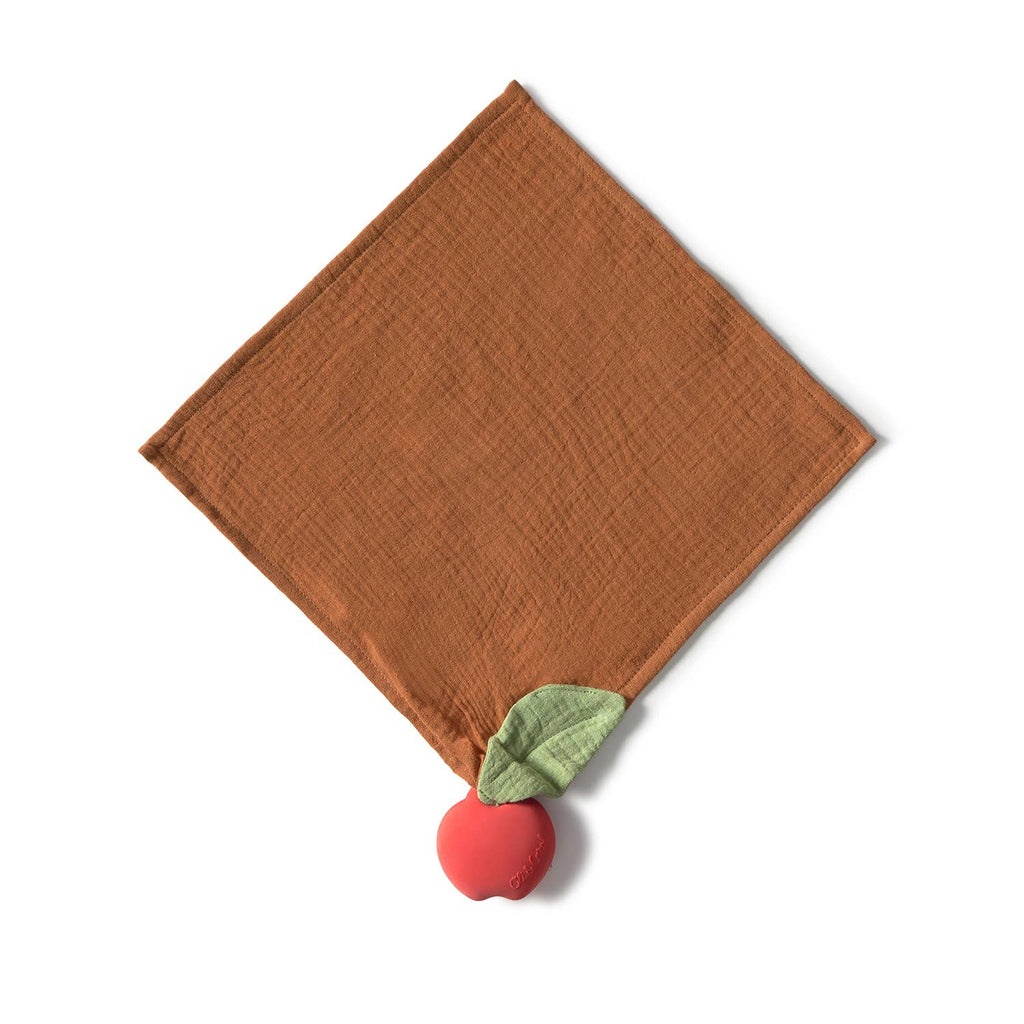 The Pepa the Apple Big Doudou, made of brown organic cotton, is diamond-shaped with a red apple-shaped natural rubber teether and a green leaf attached to one corner, shown on a white background.
