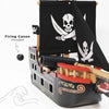 The Barbarossa Pirate Ship & Characters (ships in one week) is a black wooden pirate ship toy with skull and crossbones flags, firing cannon that shoots a ball, and the text "Firing Canon Included" with an illustrated hand pointing to the cannonball.