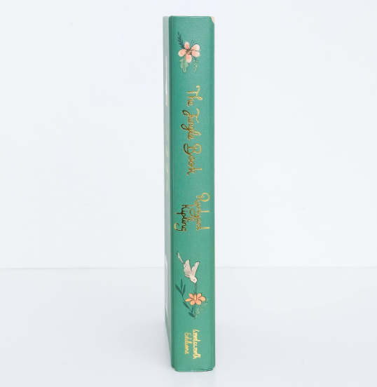 The Collector's Edition of "The Jungle Book" by Kipling is a green hardcover with gold text and adorned with small floral and bird illustrations on the spine, exuding elegance.