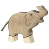 A handcrafted wooden elephant toy with a simplistic design, featuring a curved trunk raised upwards. Made in Europe, the elephant is painted in muted brown and cream tones, with minimal facial features and a small tail made of dark string. Perfectly aligns with the charm of Holztiger Elephant, Trunk Raised.