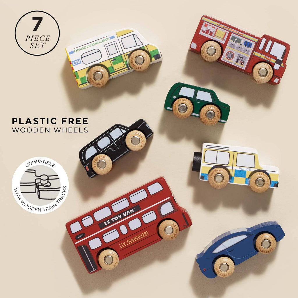 The London Toy Car Set features seven colorful wooden London vehicles—buses, cars, ambulance, police car—on a beige background. Text: "Plastic Free," "Wooden Wheels," "Compatible with Wooden Train Tracks.
