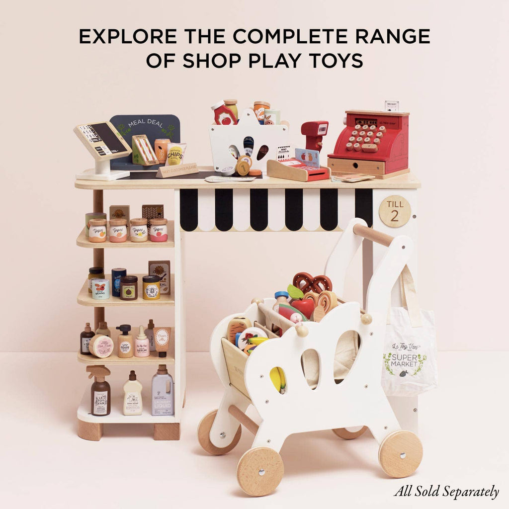 The Cash Register & Money set includes a wooden toy cash register, shelves with play groceries, and Le Toy Van food items. "Explore the complete range of educational toy shop play sets.