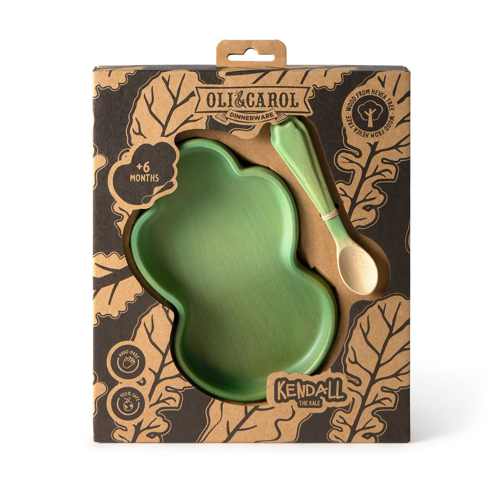 The Kendall the Kale Plate & Spoon Set is a green, cloud-shaped baby dinnerware set that includes a non-toxic plate and spoon, thoughtfully crafted and packaged in a brown box adorned with leafy patterns. Labeled “Oli&Carol” and “Kendall the Kale,” this set is designed for babies aged 6 months and up. Made from sustainable Hevea wood, it ensures both safety and eco-friendliness for your little one’s mealtime.