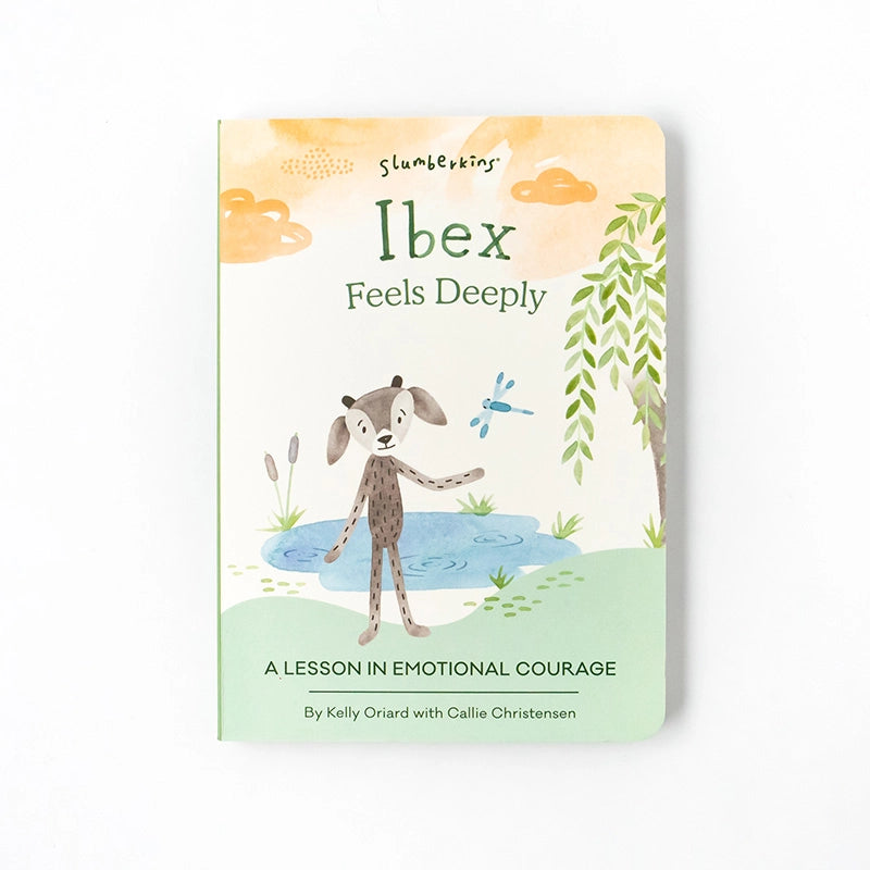 A children's companion book cover titled "Slumberkins Ibex Kin + Lesson Book On Emotional Courage" by Kelly Oriard with Callie Christensen, featuring an illustrated ibex by a pond with plants.
