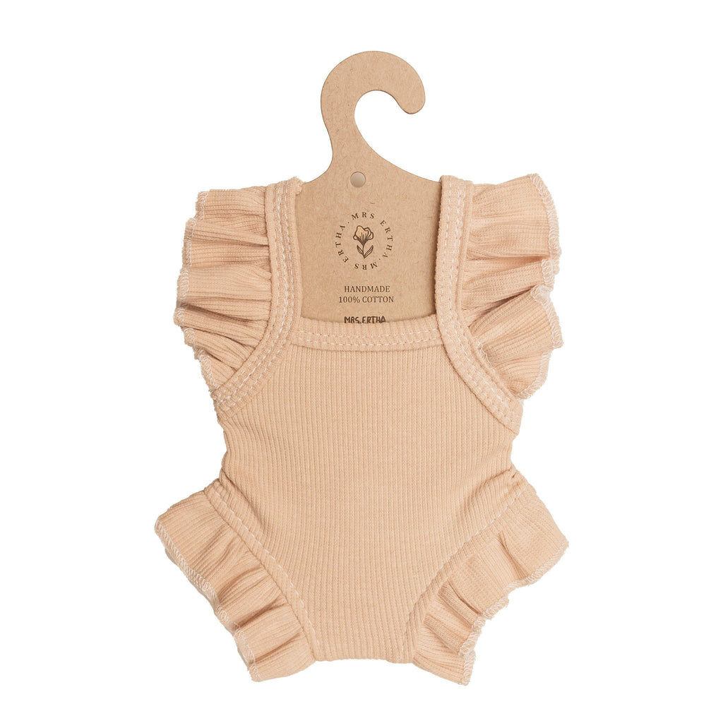 Blush Frilled Bodysuit for 13″-14″ dolls, crafted from ribbed cotton with charming ruffled sleeves and leg openings. Displayed on a cardboard hanger labeled “Handmade 100% cotton,” this handmade doll clothes piece is perfectly sized for Minikane dolls and adds a delightful touch to any collection.
